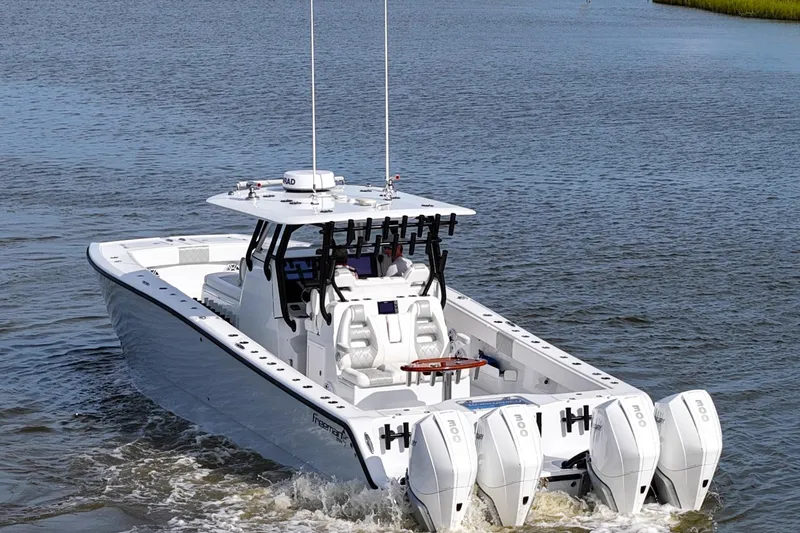 Slide: The Image of 2022 Freeman 37VH boat with quad outboard engines cruising on water. - 11