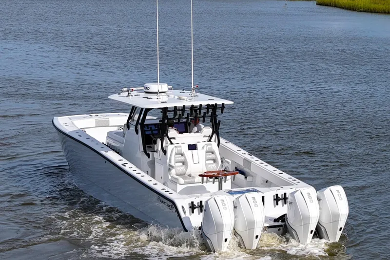 Slide: The Image of Freeman 37VH 2022 boat with quad engines cruising on water. - 12