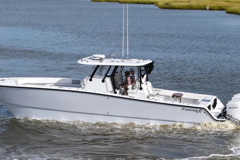 Slide: The Image of 2022 Freeman 37VH boat cruising on a calm waterway. - 14