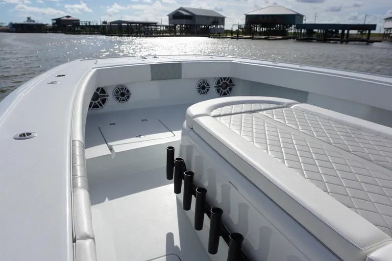 Slide: The Image of 2022 Freeman 37VH boat interior with quilted seating and rod holders, dockside view. - 18