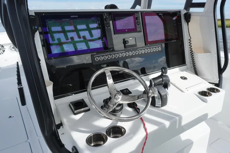 Slide: The Image of Control panel of a 2022 Freeman 37VH boat with advanced navigation displays. - 24