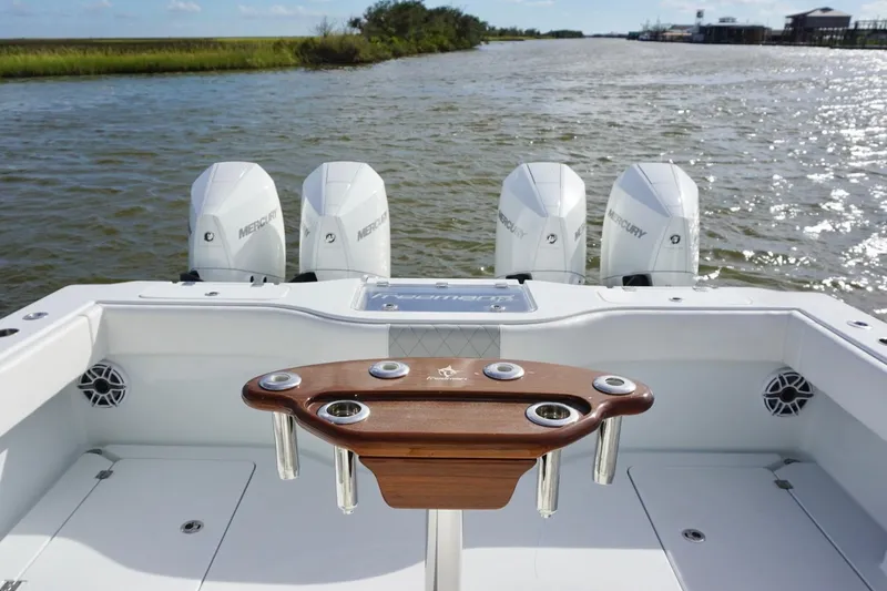 Slide: The Image of 2022 Freeman 37VH boat with four Mercury engines on a calm waterway. - 28