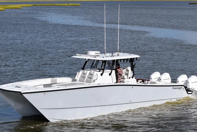 Slide: The Image of 2022 Freeman 37VH boat cruising on water with multiple outboard engines. - 3