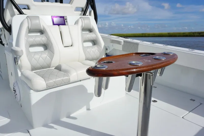Slide: The Image of Luxury seating and rod holders on 2022 Freeman 37VH boat, with scenic water backdrop. - 30