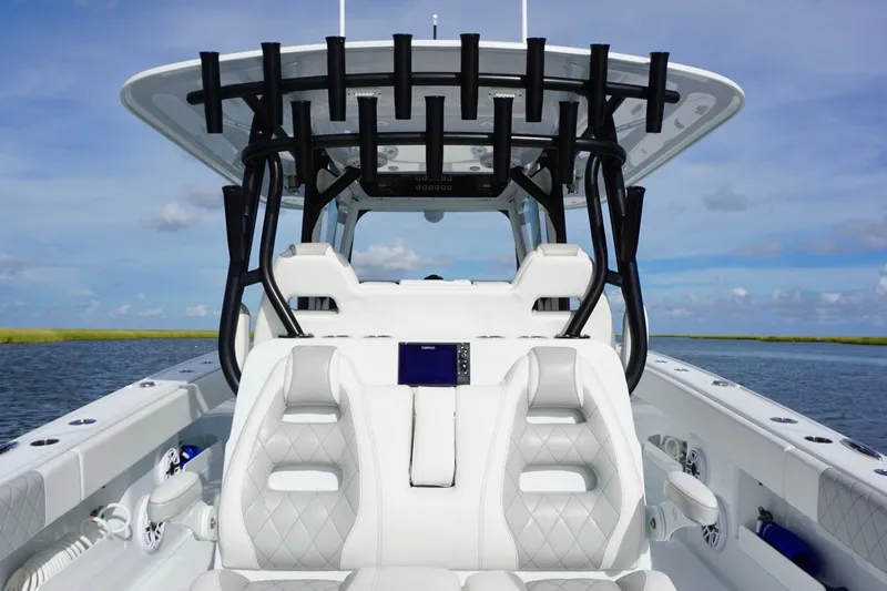 Slide: The Image of Freeman 37VH 2022 boat interior with luxurious seating and rod holders on a sunny day. - 33