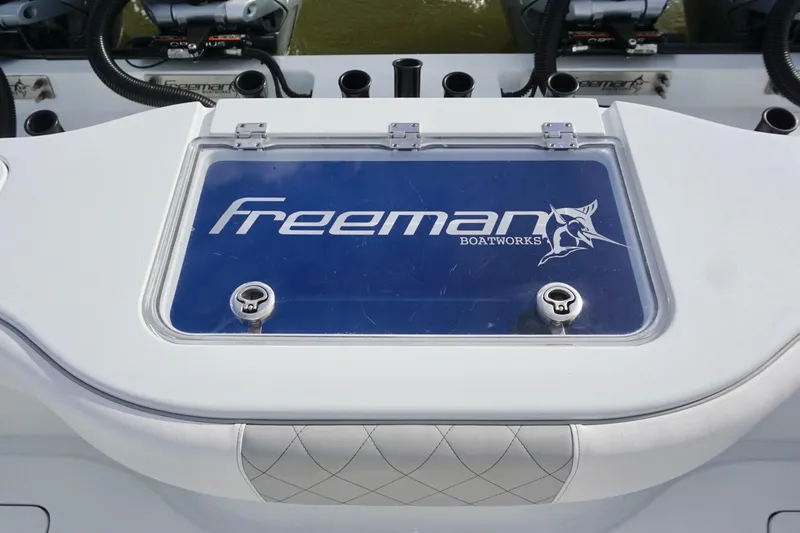 Slide: The Image of Freeman 37VH 2022 boat livewell with logo and fishing rod holders. - 36