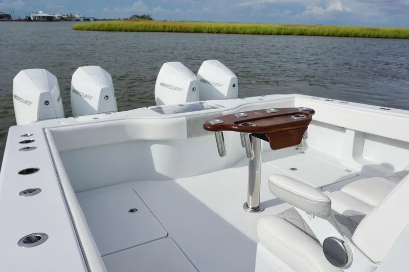 Slide: The Image of Freeman 37VH 2022 boat with Mercury engines, featuring a sleek white deck and seating. - 38