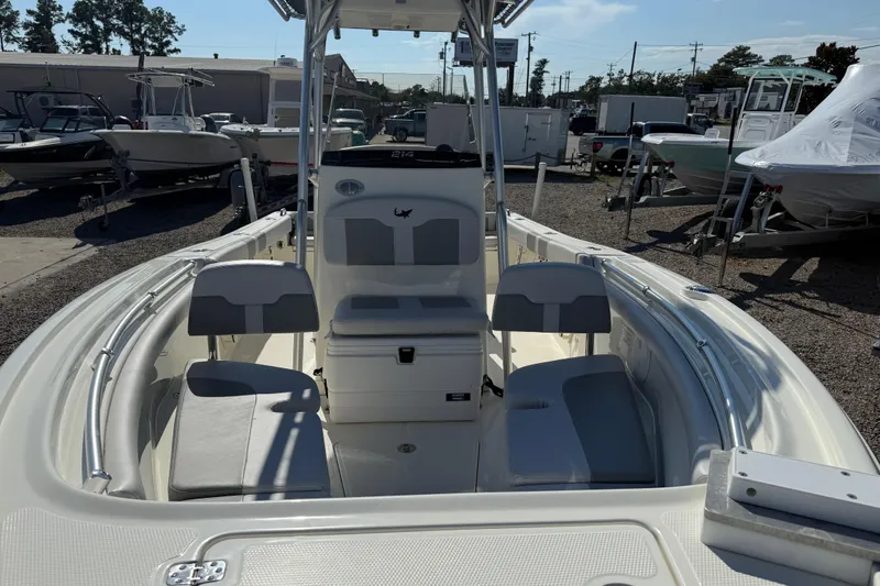 Slide: The Image of 2021 Mako 214 Center Console boat with seating and storage, displayed outdoors. - 11