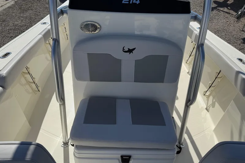 Slide: The Image of 2021 Mako 214 Center Console boat interior with cushioned seating and stainless steel rails. - 13