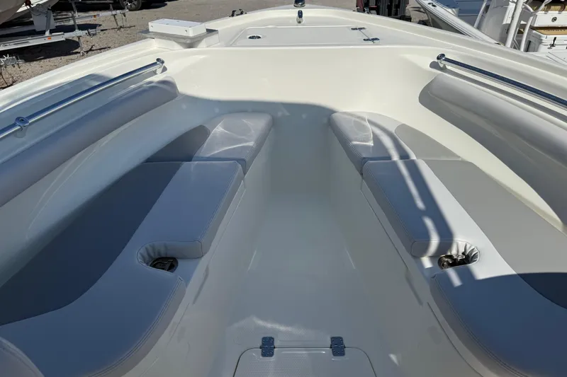 Slide: The Image of 2021 Mako 214 Center Console boat interior with cushioned seating and storage compartments. - 14