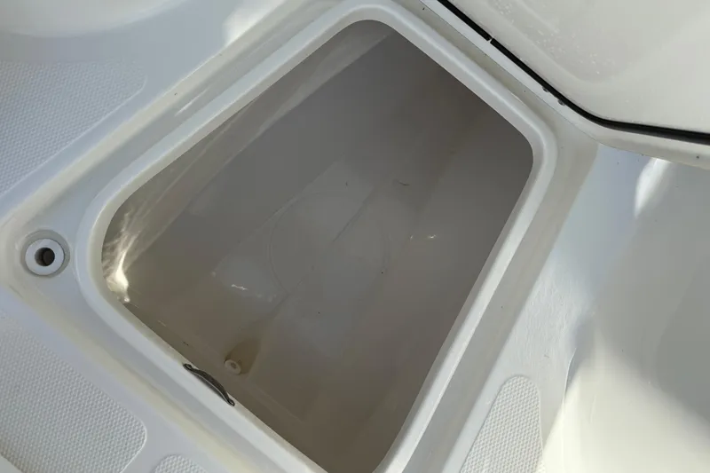 Slide: The Image of Open storage compartment on 2021 Mako 214 Center Console boat. - 16