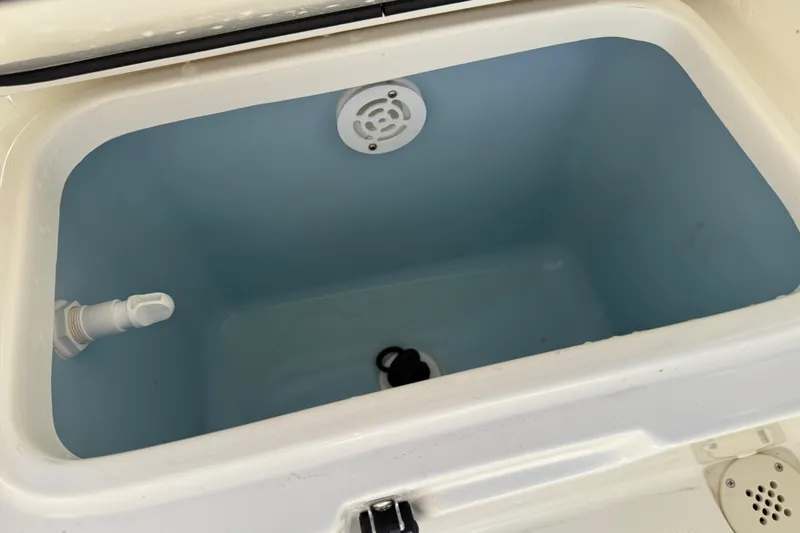 Slide: The Image of Livewell in 2021 Mako 214 Center Console boat, featuring drain and water inlet. - 20