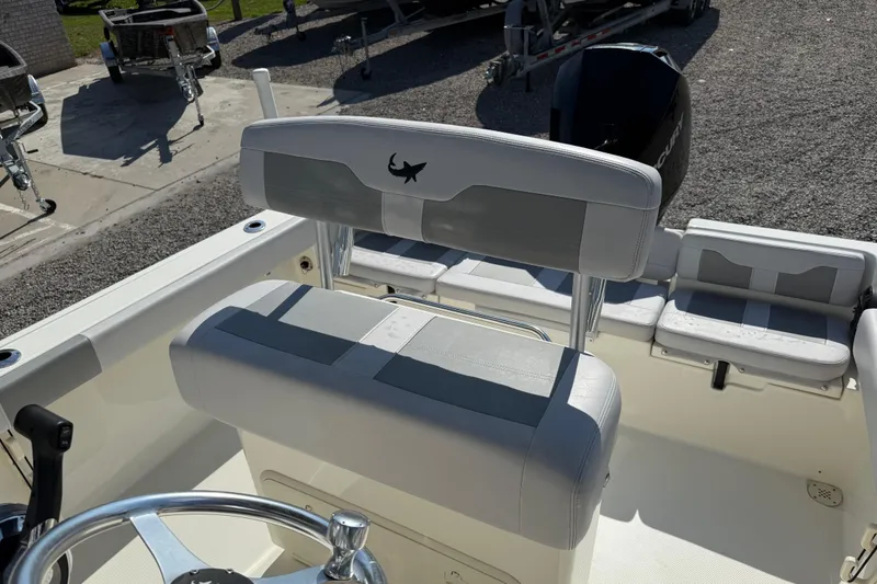 Slide: The Image of 2021 Mako 214 Center Console boat interior with seating and steering wheel. - 23