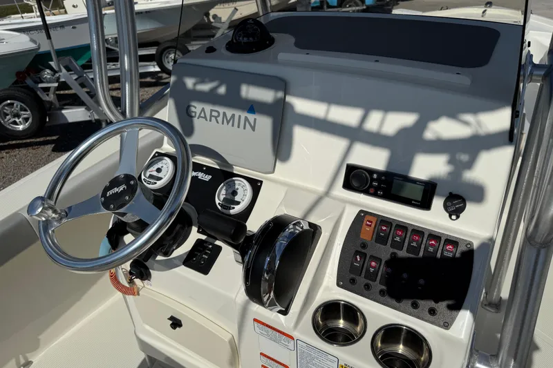 Slide: The Image of 2021 Mako 214 Center Console boat dashboard with Garmin navigation system and controls. - 24
