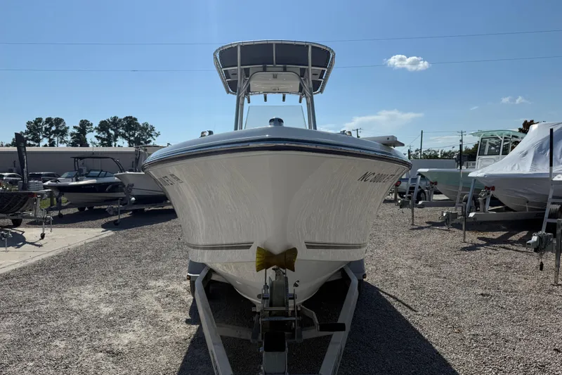 Slide: The Image of 2021 Mako 214 Center Console boat on trailer in outdoor lot. - 3