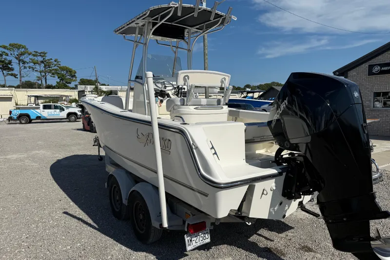 Slide: The Image of 2021 Mako 214 Center Console boat with Mercury engine on trailer in outdoor setting. - 6