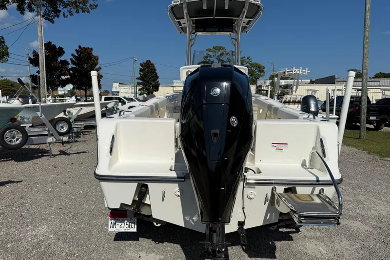Slide: The Image of 2021 Mako 214 Center Console boat with powerful outboard motor, displayed outdoors. - 8
