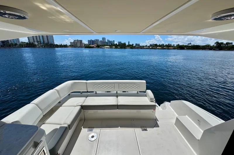 Slide: The Image of Luxury seating area on 2022 Regal 42 XO yacht overlooking serene waterfront. - 10