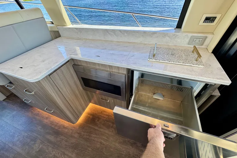 Slide: The Image of Luxurious 2022 Regal 42 XO yacht kitchen with modern appliances and ocean view. - 13