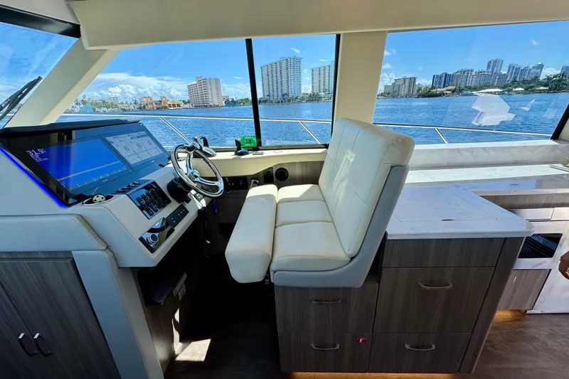 Slide: The Image of Interior of 2022 Regal 42 XO yacht with modern helm and waterfront view. - 16