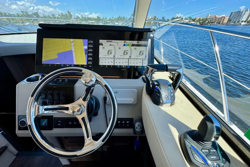 Slide: The Image of Cockpit of 2022 Regal 42 XO yacht with navigation screens and steering wheel. - 18