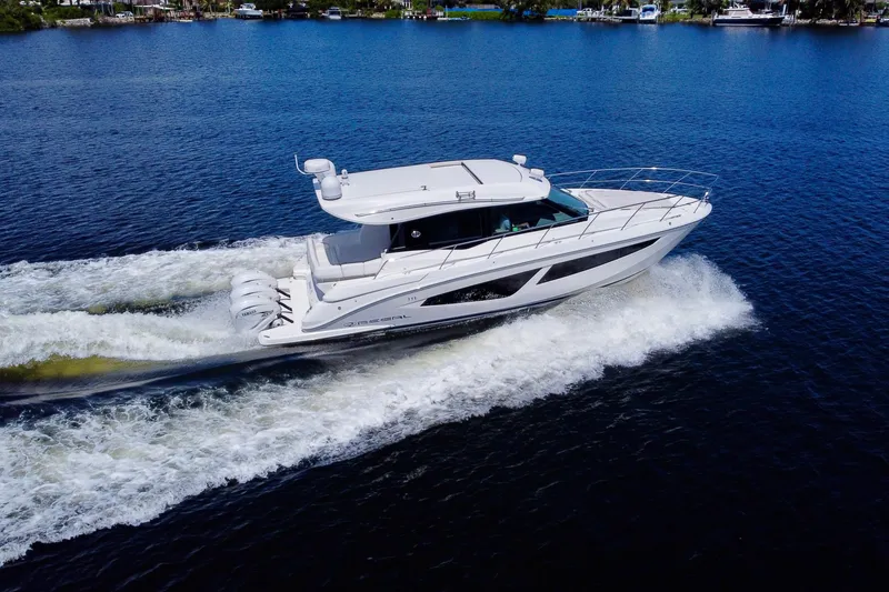 Slide: The Image of 2022 Regal 42 XO yacht cruising on a serene blue lake. - 2