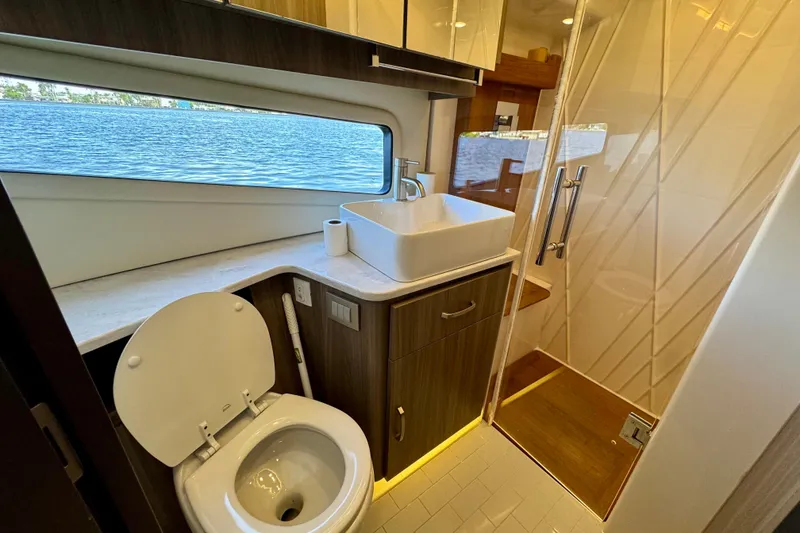 Slide: The Image of Luxurious bathroom in 2022 Regal 42 XO yacht with modern fixtures and scenic window view. - 23