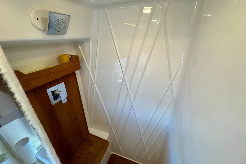 Slide: The Image of 2022 Regal 42 XO yacht interior with modern shower design and wooden accents. - 24