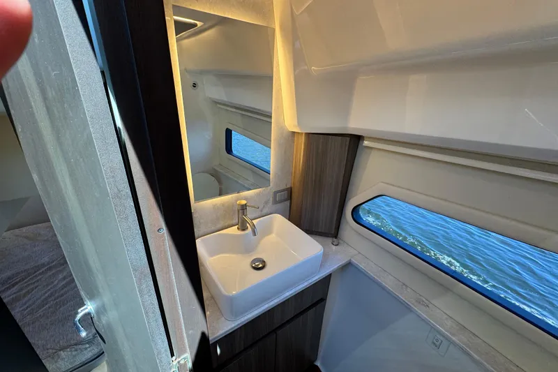 Slide: The Image of Luxurious bathroom interior of 2022 Regal 42 XO yacht with modern sink and window view. - 27