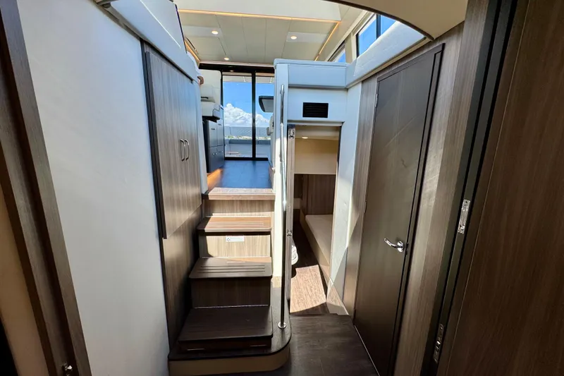 Slide: The Image of Interior view of 2022 Regal 42 XO yacht, featuring modern wood finishes and natural lighting. - 28