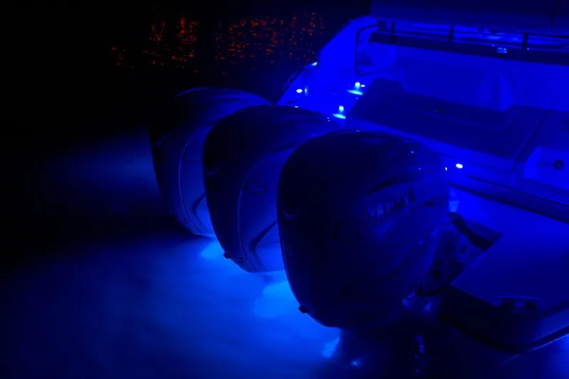 Slide: The Image of 2022 Regal 42 XO boat with illuminated blue LED lights at night. - 32
