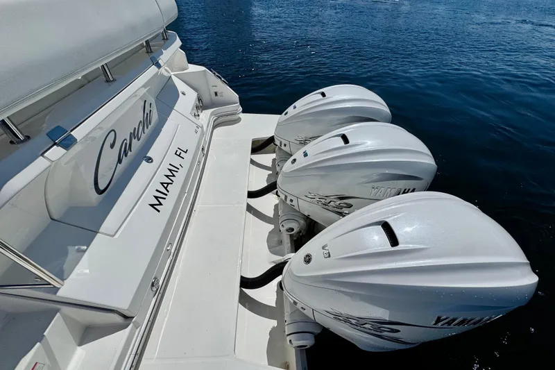 Slide: The Image of 2022 Regal 42 XO boat with triple Yamaha outboard engines, docked in Miami, FL. - 4