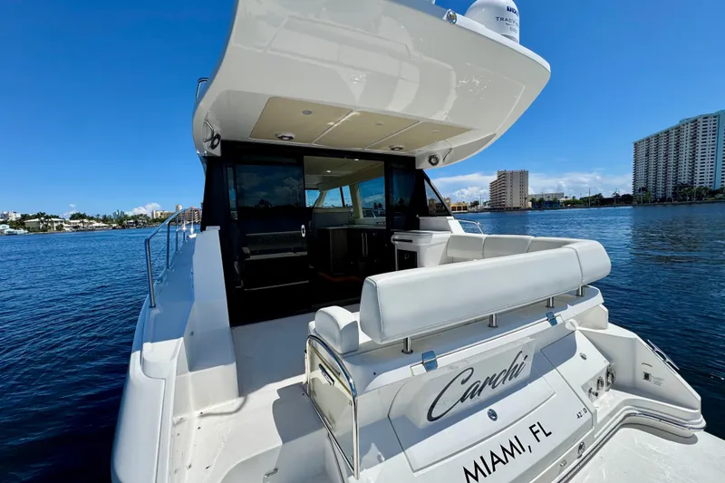 Slide: The Image of 2022 Regal 42 XO yacht docked in Miami, Florida, with luxurious seating and sleek design. - 5