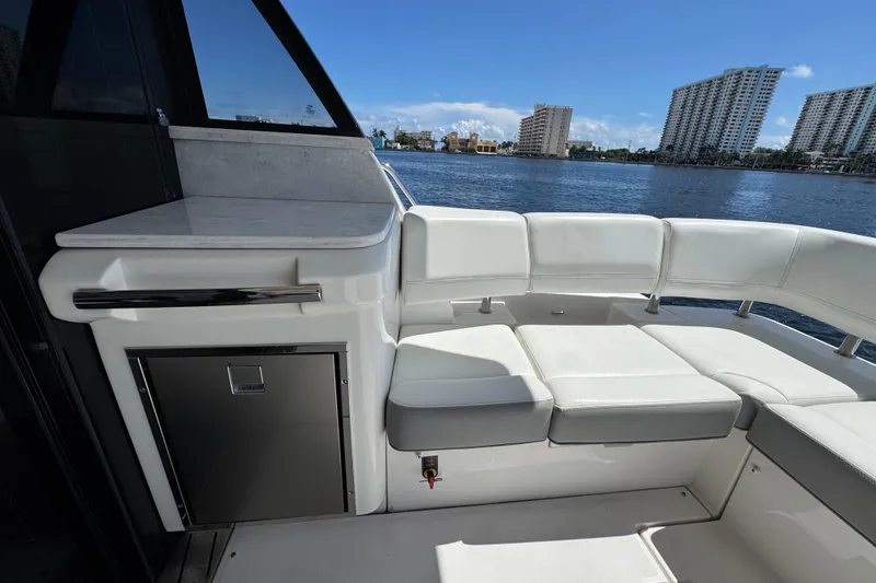 Slide: The Image of Luxurious seating area on 2022 Regal 42 XO yacht with waterfront view. - 7