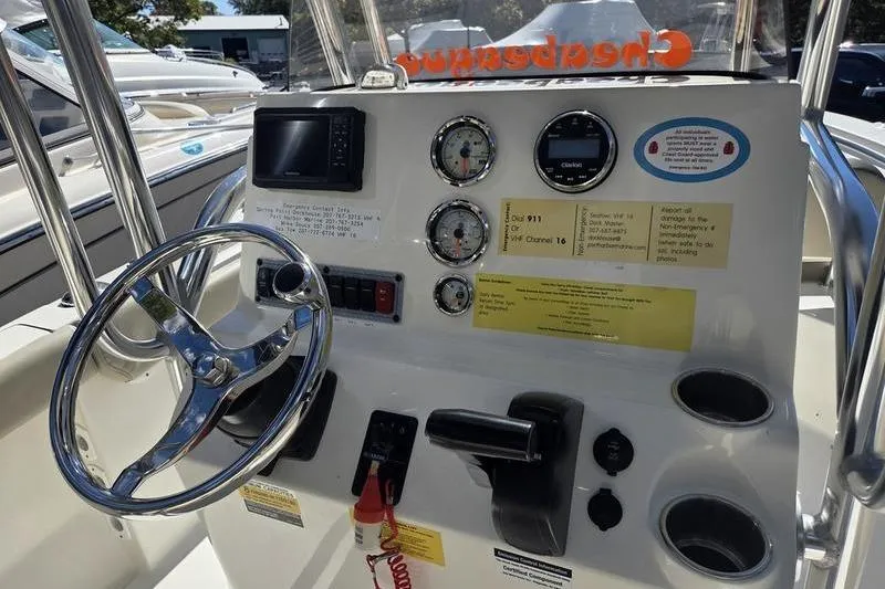Slide: The Image of 2023 Key West 203 FS boat dashboard with steering wheel and gauges. - 10