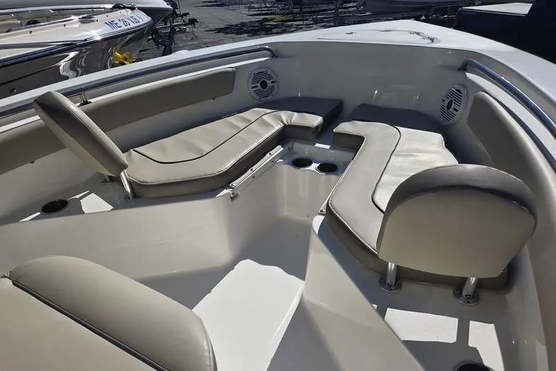 Slide: The Image of 2023 Key West 203 FS boat interior with cushioned seating and cup holders. - 11
