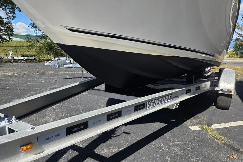 Slide: The Image of 2023 Key West 203 FS boat on a Venture trailer in a parking lot. - 13