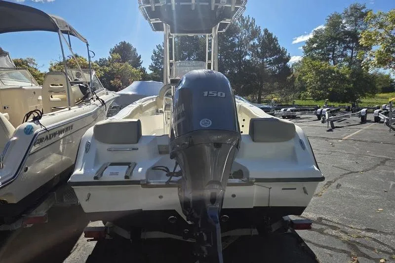 Slide: The Image of 2023 Key West 203 FS boat with Yamaha 150 engine, parked outdoors. - 3