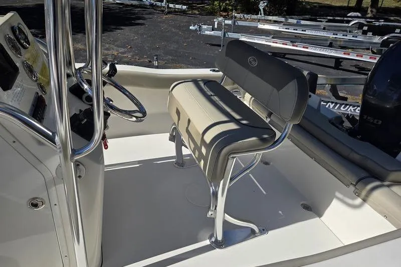 Slide: The Image of 2023 Key West 203 FS boat interior with steering console and seating. - 4