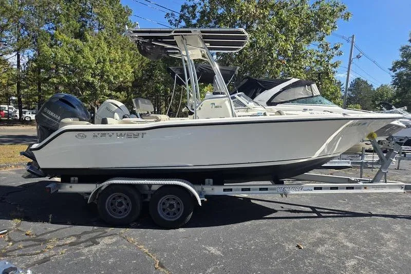 Slide: The Image of 2023 Key West 203 FS boat on trailer, parked outdoors, side view. - 6