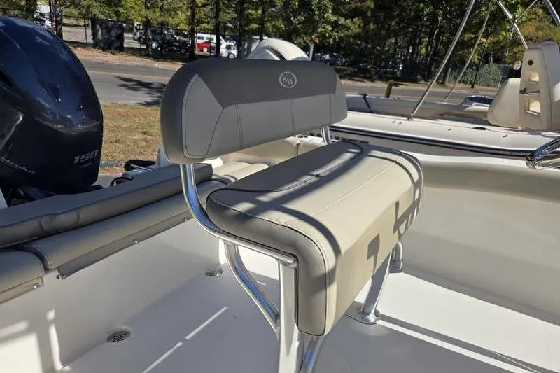 Slide: The Image of 2023 Key West 203 FS boat interior with cushioned seating and stainless steel frame. - 9