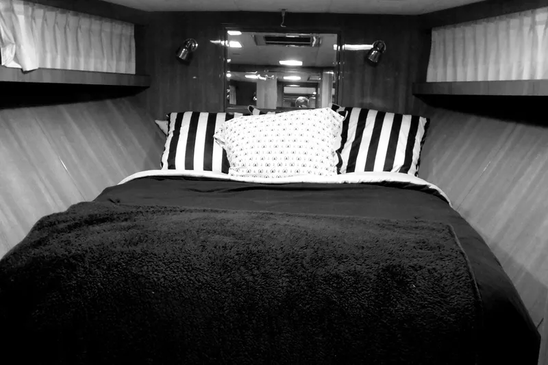 Slide: The Image of Luxurious bedroom in 2001 Jefferson Pilothouse 57 yacht with nautical-themed decor. - 23