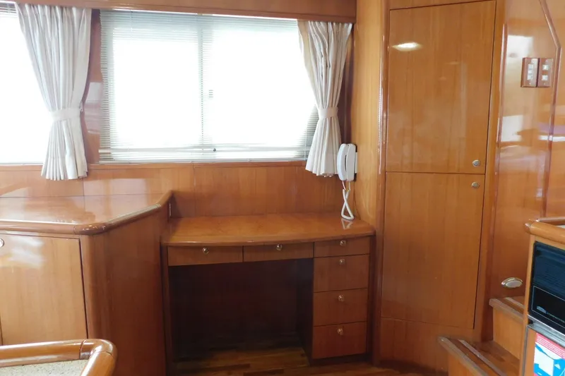 Slide: The Image of Luxurious bedroom in 2001 Jefferson Pilothouse 57 yacht with striped bedding and wooden accents. - 29