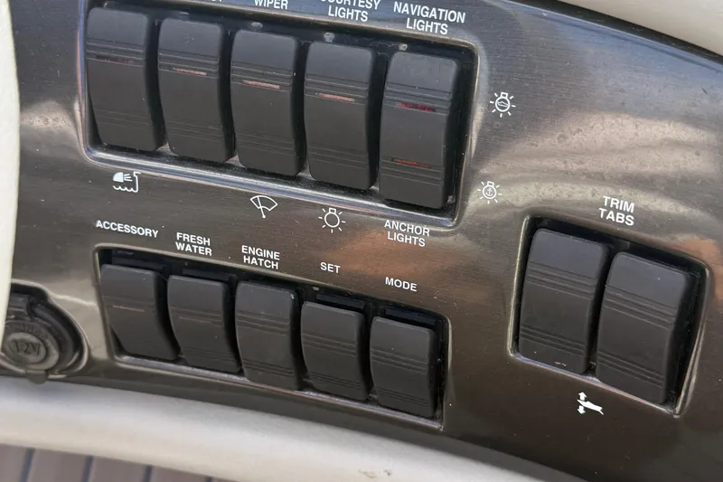 Slide: The Image of Control panel of a 2000 Four Winns 260 Horizon boat with various switches. - 10
