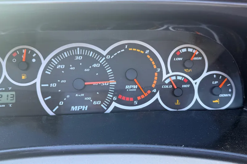 Slide: The Image of Dashboard of a 2000 Four Winns 260 Horizon boat showing speedometer and gauges. - 12