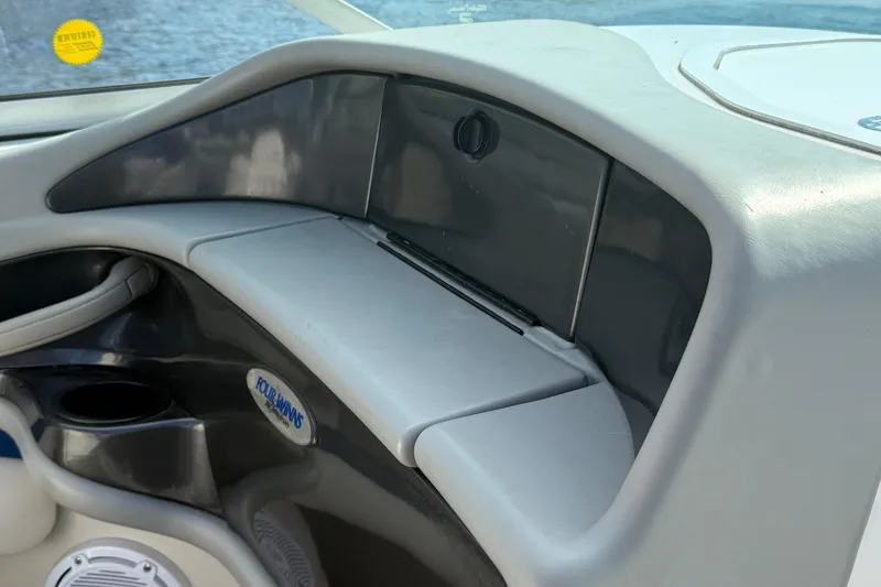 Slide: The Image of Interior view of 2000 Four Winns 260 Horizon boat dashboard with storage compartment. - 13