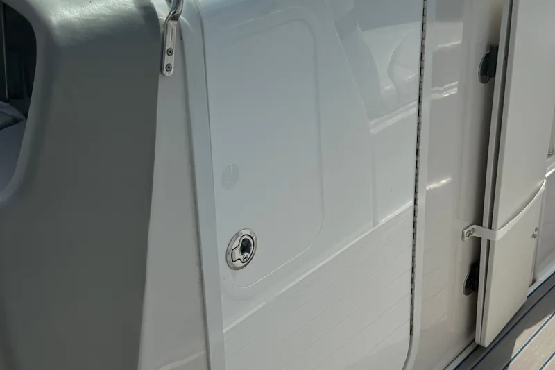 Slide: The Image of 2000 Four Winns 260 Horizon boat door detail with sleek white finish. - 14