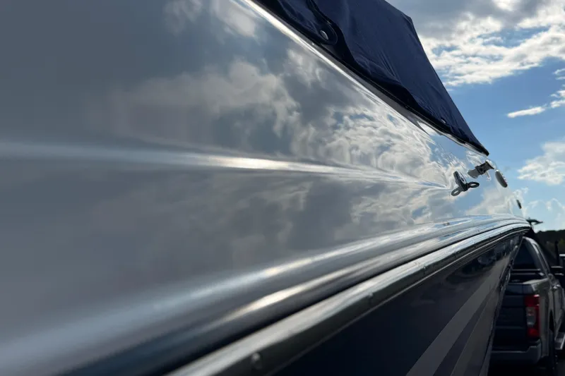 Slide: The Image of Close-up of a 2000 Four Winns 260 Horizon boat reflecting clouds. - 18