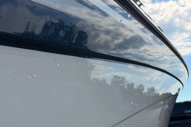 Slide: The Image of Close-up of 2000 Four Winns 260 Horizon boat hull reflecting sky and clouds. - 19