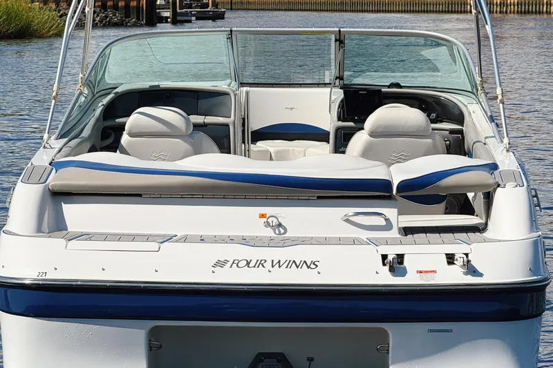 Slide: The Image of 2000 Four Winns 260 Horizon boat, rear view, on water, showcasing seating and deck. - 20